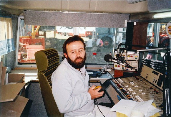 Outside broadcast van with presenter and desk