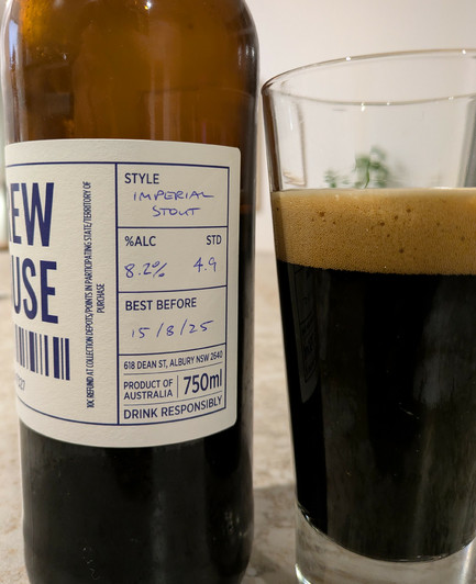 Bottle of stout next to a glass