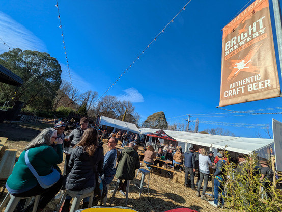 Early festival goers listening to music and having a beer
