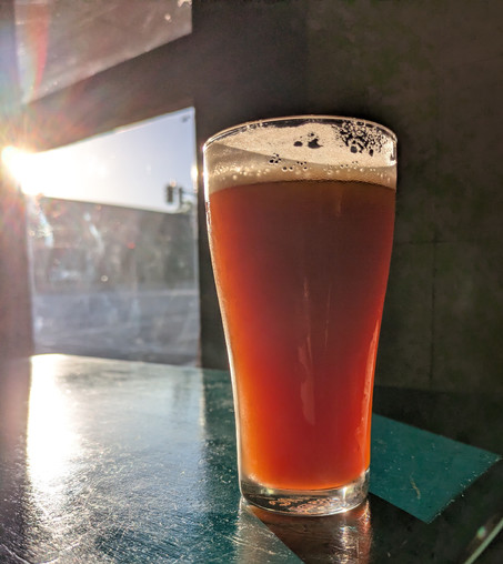 A glass of brown beer